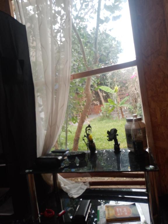 a window with two toy figurines on a table at Bugambilia house in La Tinguiña