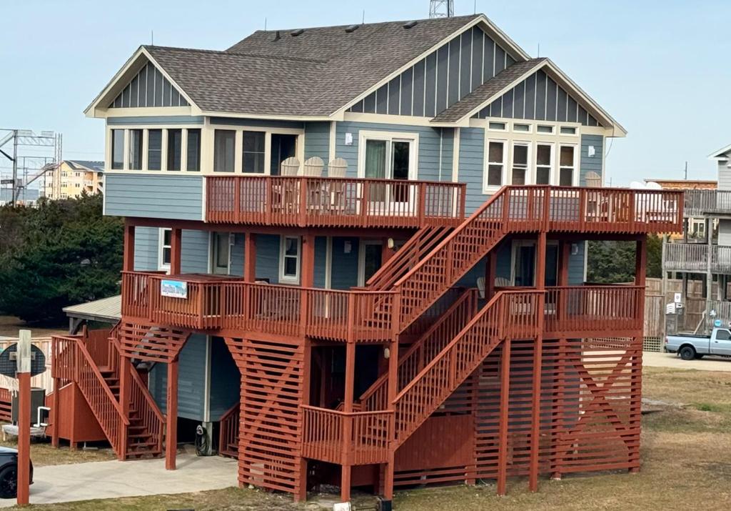 a house with a spiral staircase in front of it at Carolina Breeze in Rodanthe
