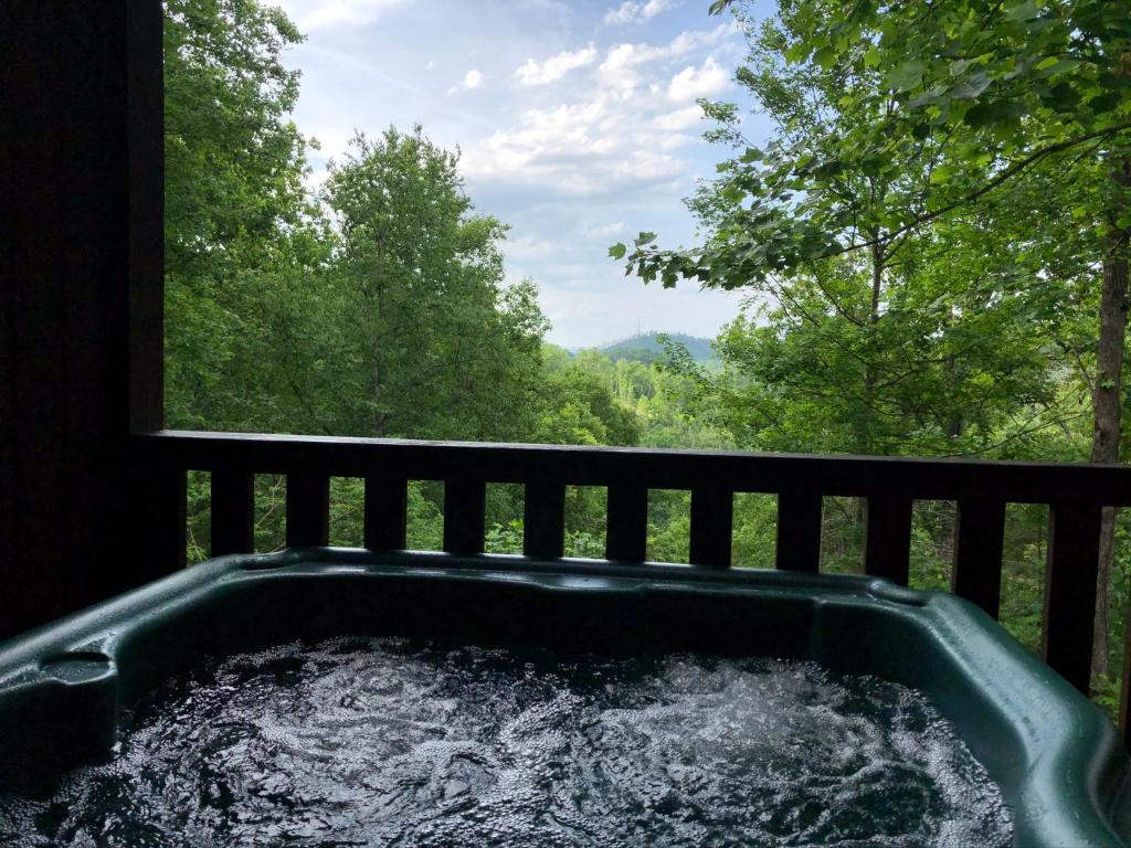 a tub filled with water next to a window at Black Bear Cove in Gatlinburg