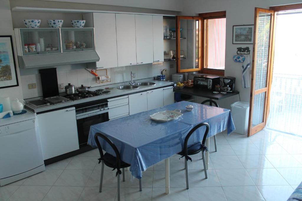 a kitchen with a table with a blue table cloth on it at Casa Vacanze Mascali in Riposto