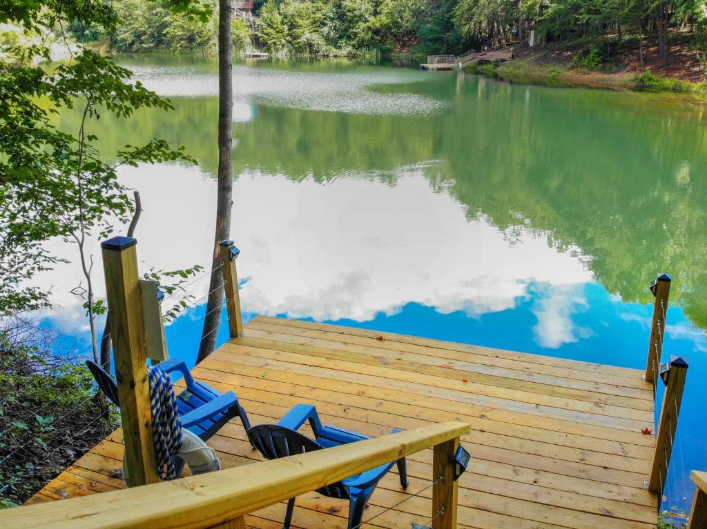 a wooden dock with two chairs sitting on top of a lake at Sunset Ridge in Sevierville