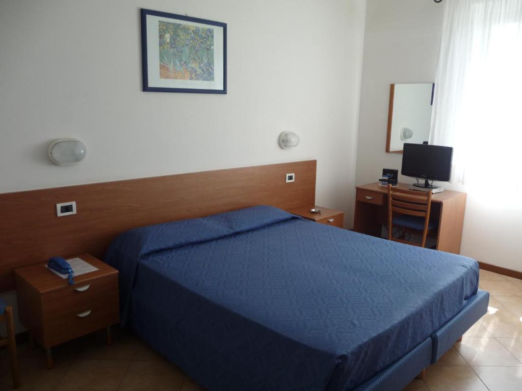 Postel nebo postele na pokoji v ubytování Hotel La Toscana