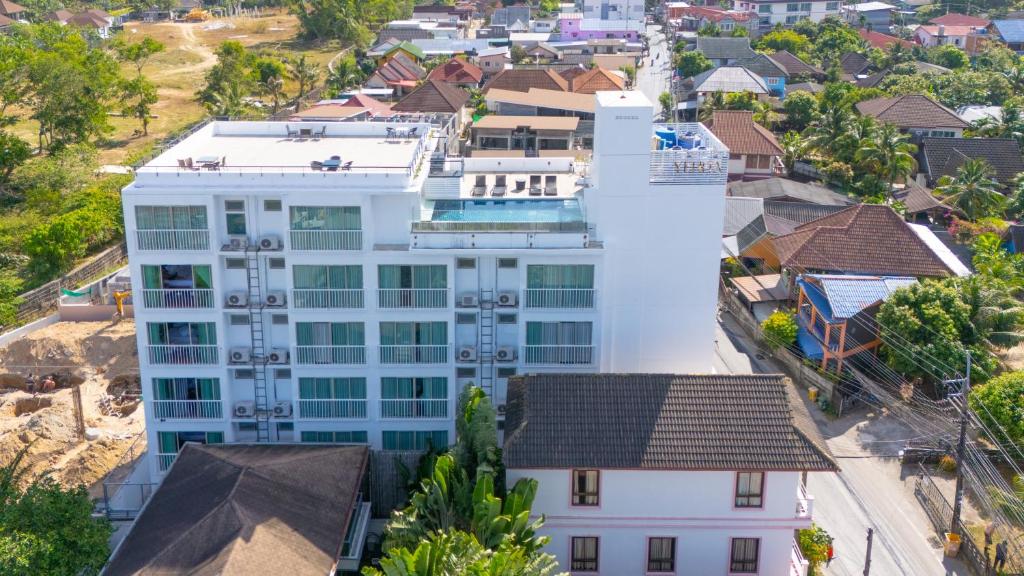 an aerial view of a white building in a city at Yenna Apartment in Kamala Beach
