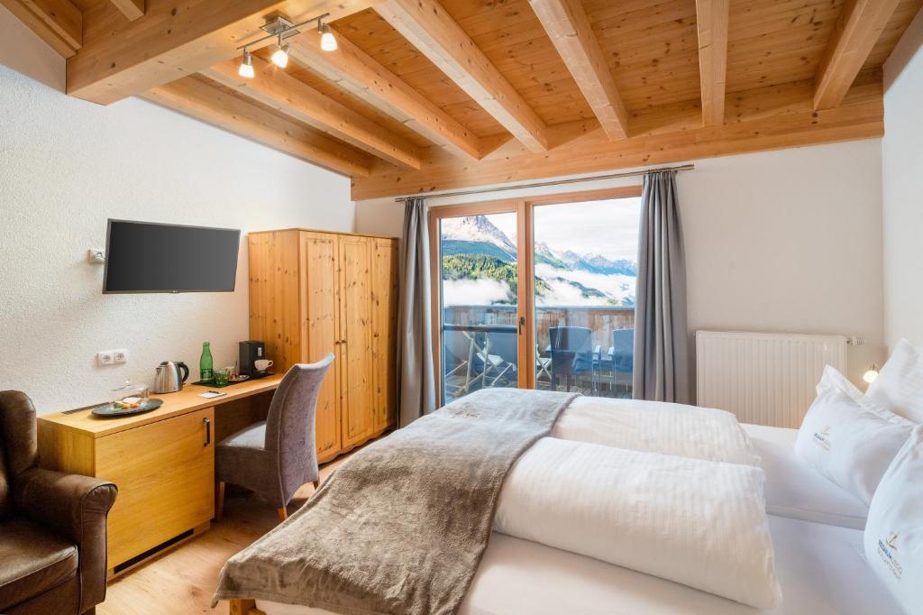 Postel nebo postele na pokoji v ubytování Hotel Regnum Zegg