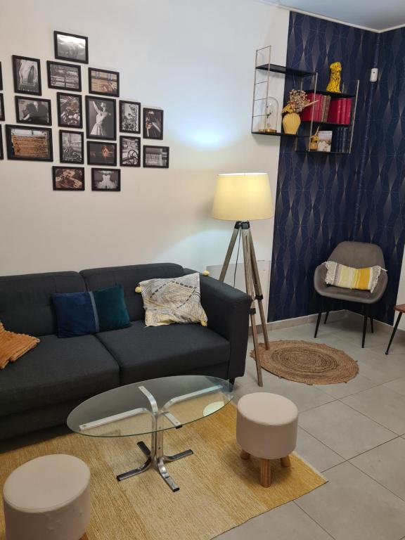 a living room with a couch and a table at Maison à deux pas de l'hôtel de ville in Calais
