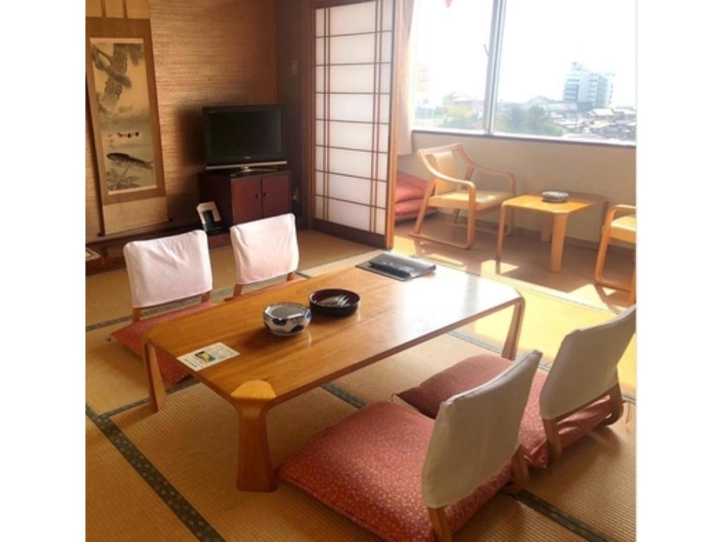 a living room with a table and chairs at Hotel Tetora Resort Tsuruoka - Vacation STAY 39373v in Tsuruoka