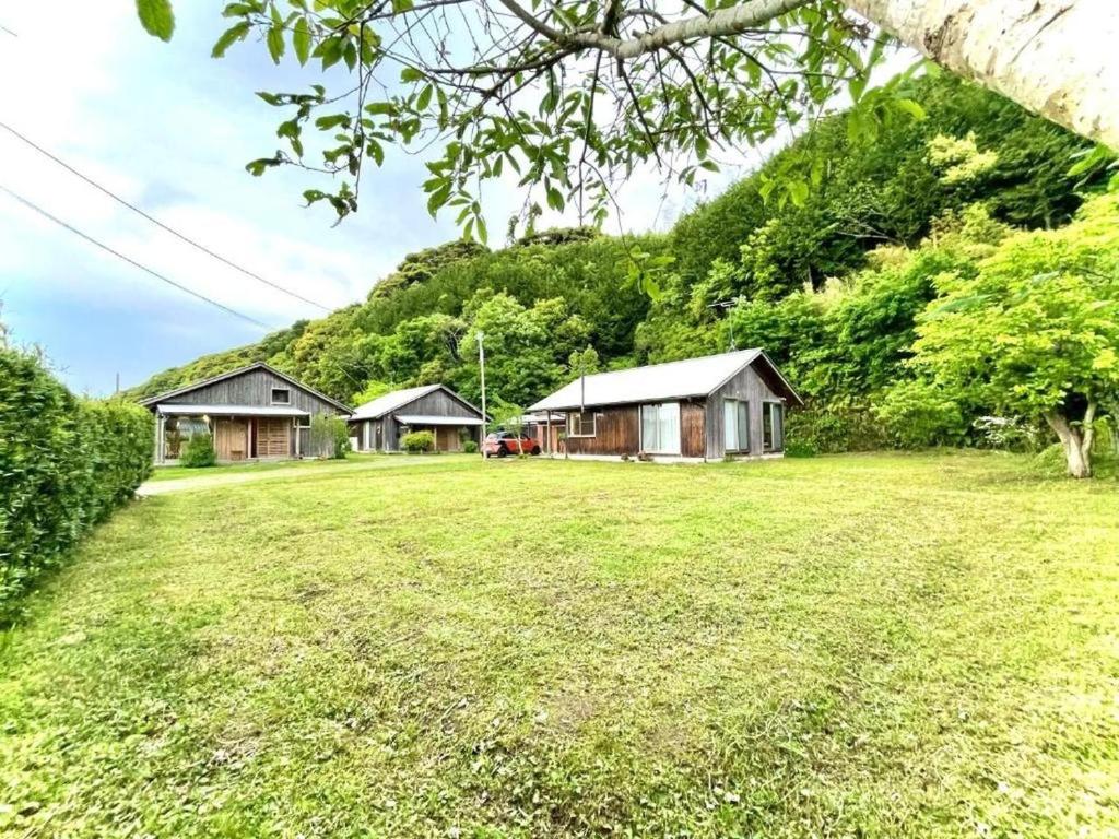 a group of cottages in a field of grass at Gubo Satoyama Suite Lodge & Camp - Vacation STAY 39510v in Katsuura