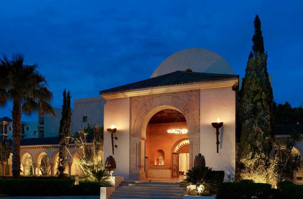 un edificio con un arco en un patio en The Residence Tunis, en Gammarth