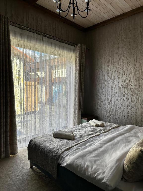a bedroom with a bed with a large window at Old Town in Çilǝgir