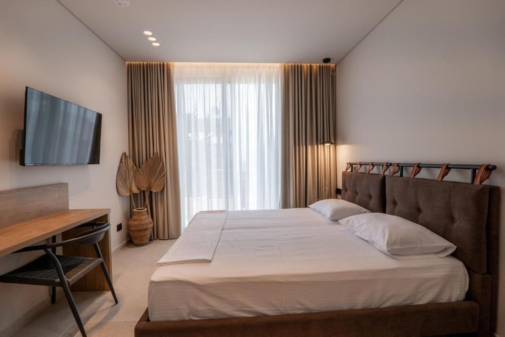 Postel nebo postele na pokoji v ubytování Kamara Rooms