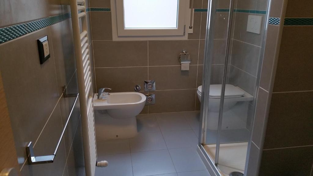 a bathroom with a toilet and a sink and a shower at In Fiera 14 Apartment in Bologna