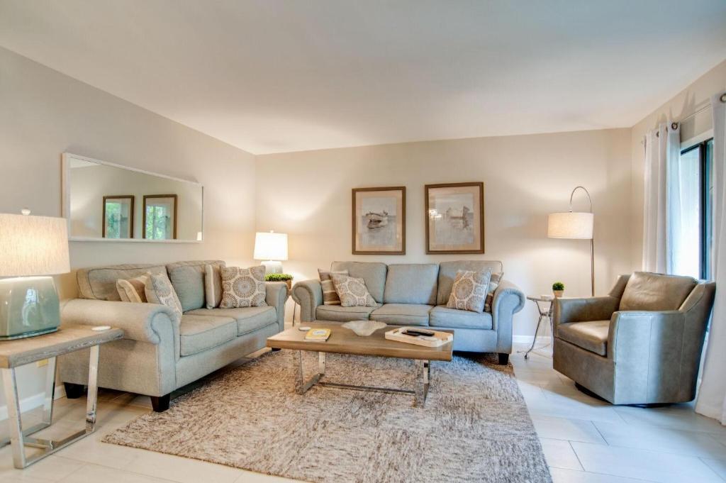 a living room with two couches and a table at Clipper Court 816 in Hilton Head Island