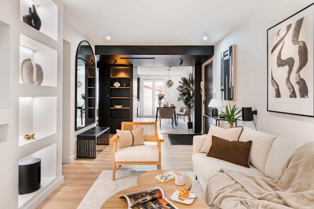 a living room with a couch and a table at La consulte - exceptional apartment in Saint-Étienne