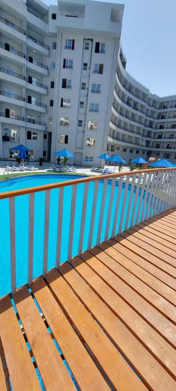 a swimming pool in front of a large building at Zahabia Golden Beach Resort Down Town in Hurghada