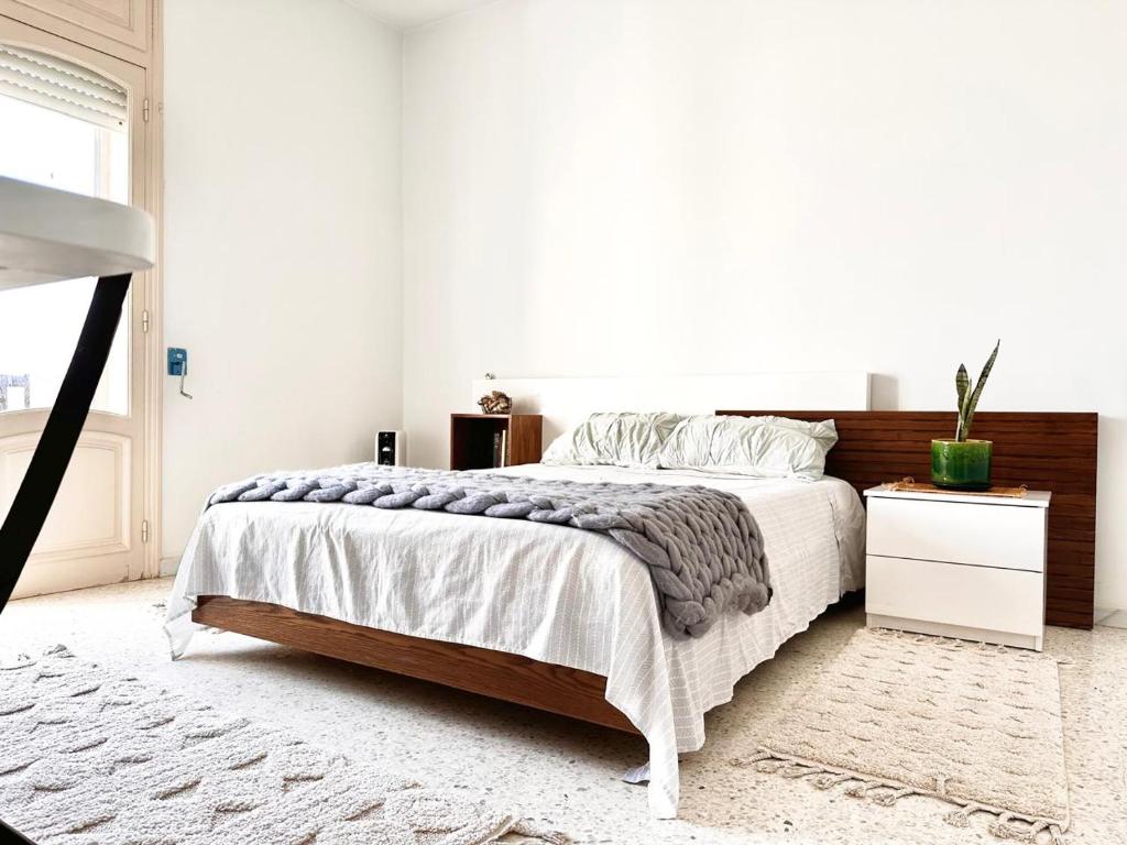 a bedroom with a large bed with a wooden headboard at Villa Olivier in Sakiet ez Zit