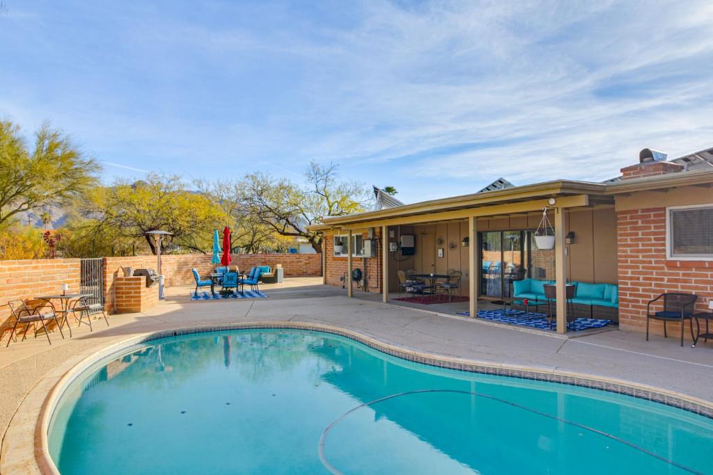 a swimming pool in front of a house at Private Pool & Fire Pit! Walkable Tucson Retreat in Tucson