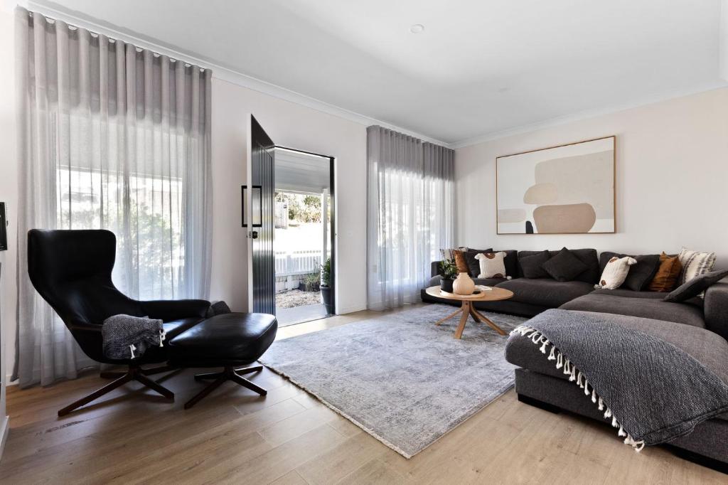 a living room with a couch and a chair at Fox on Church in Hepburn Springs