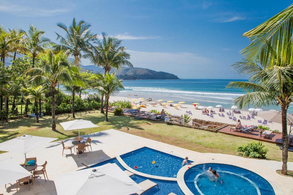 an aerial view of the beach and pool at a resort at Amora Hotel Maresias in Maresias