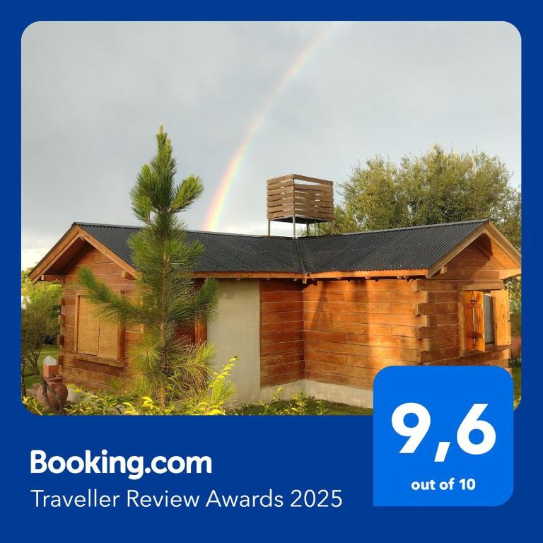 a rainbow over a house with a house at Cabaña en Villa Amancay in Villa Amancay
