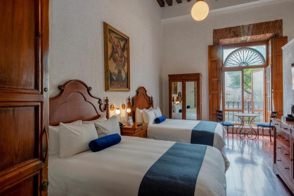 Postel nebo postele na pokoji v ubytování Hotel Los Juaninos