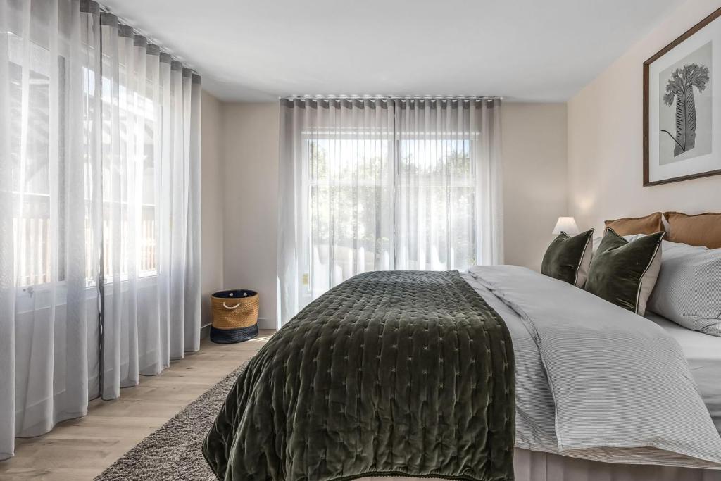 a bedroom with a large bed and a large window at Roxy on Church in Hepburn Springs