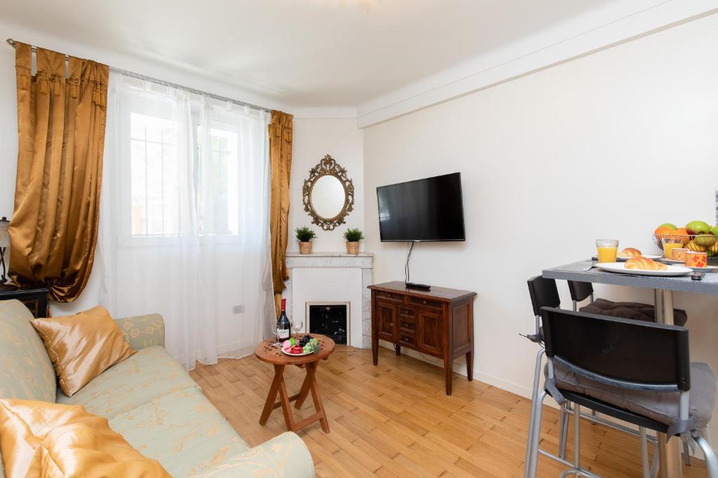 un salon avec un canapé et une télévision dans l'établissement Pelige 3 YourHostHelper, à Cannes