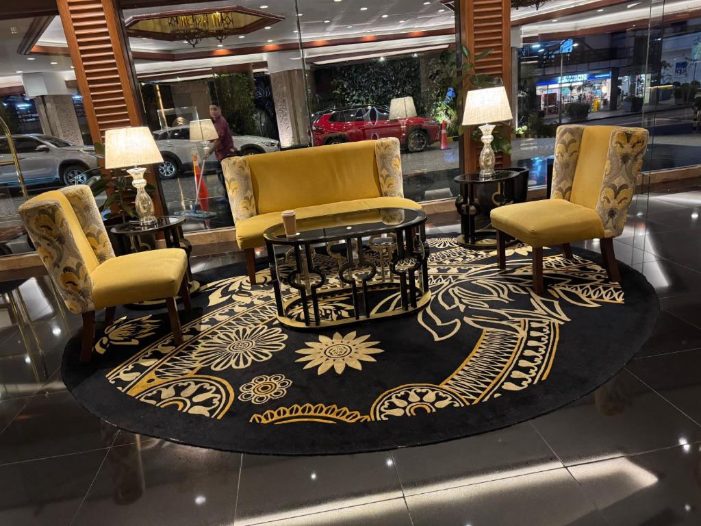 a store with two chairs and a table and a rug at Large Family Groups in Air residence Makati Gym Swim Park 300 mbps in Manila