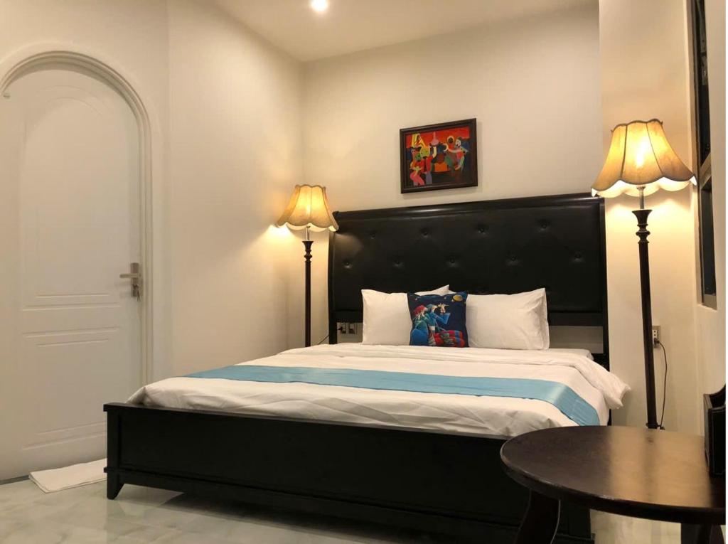 Postel nebo postele na pokoji v ubytování Longs Beach House - Wonderland Hồ Tràm
