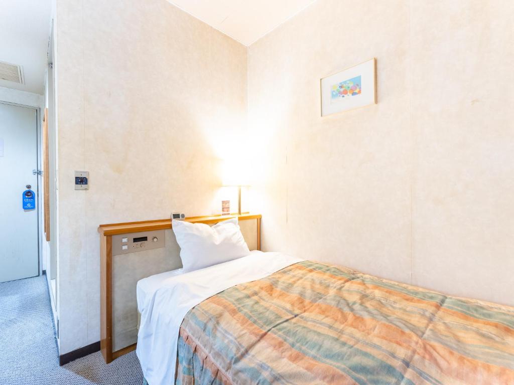Postel nebo postele na pokoji v ubytování Tabist Hotel Mercury Asakusabashi