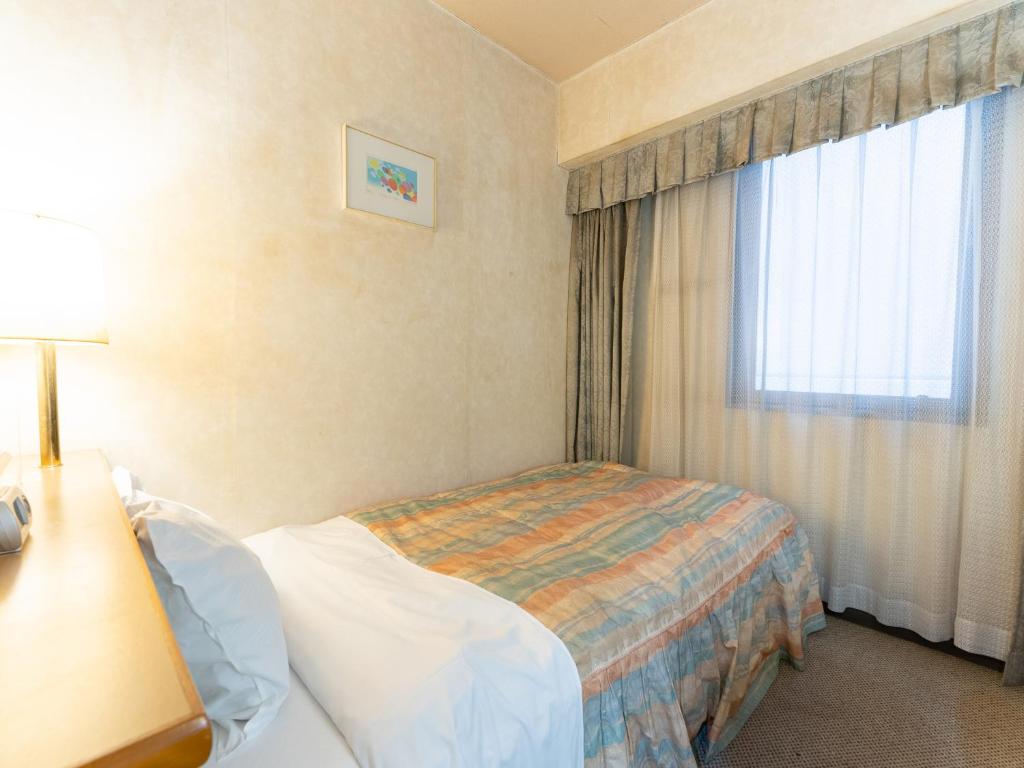Postel nebo postele na pokoji v ubytování Tabist Hotel Mercury Asakusabashi