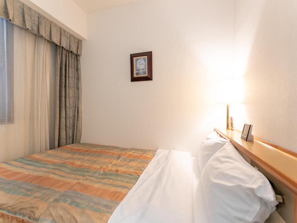 Postel nebo postele na pokoji v ubytování Tabist Hotel Mercury Asakusabashi