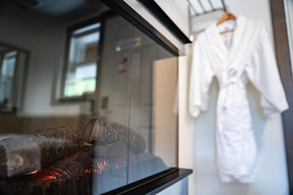 a glass display case with a white robe on a wall at Swiss Chalet Motel in Revelstoke