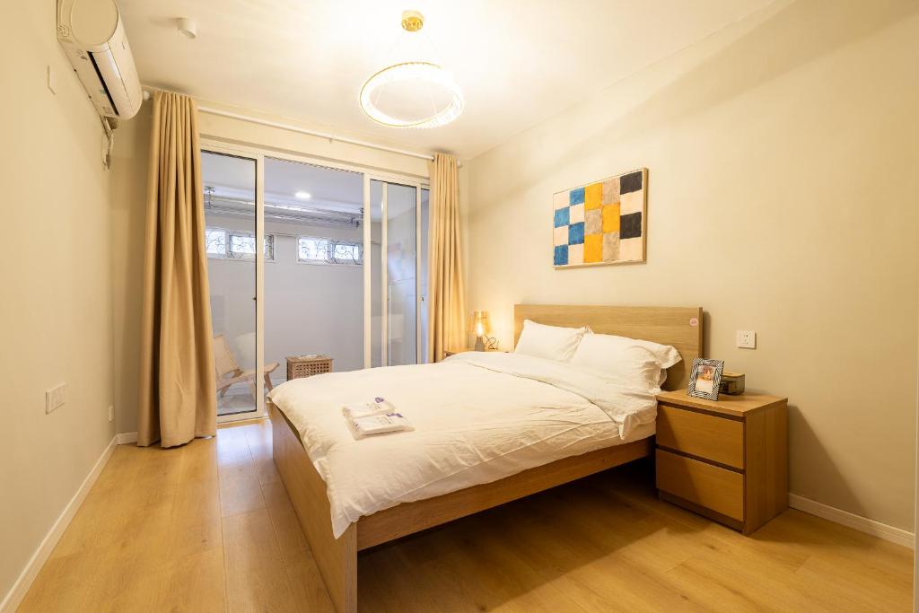 a small bedroom with a bed and a window at Shanghai Hills&Linghu's Transit-Prime Suite-Line 2, Huamu Rd 788, Direct to Key Spots & SNIEC in Shanghai