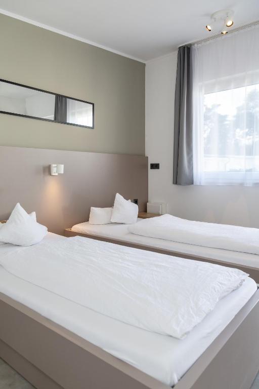 Postel nebo postele na pokoji v ubytování Hotel Lüneburg Süd