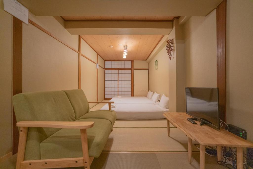 a living room with a couch and a bed at -鳴間の宿 Narumanoyado- Kyoto Aquarium-MUS in Kyoto