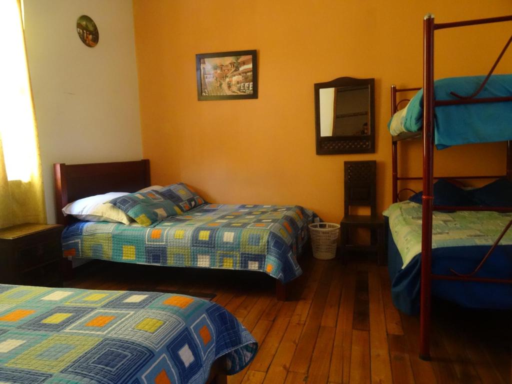 Postel nebo postele na pokoji v ubytování Hostal del Piamonte