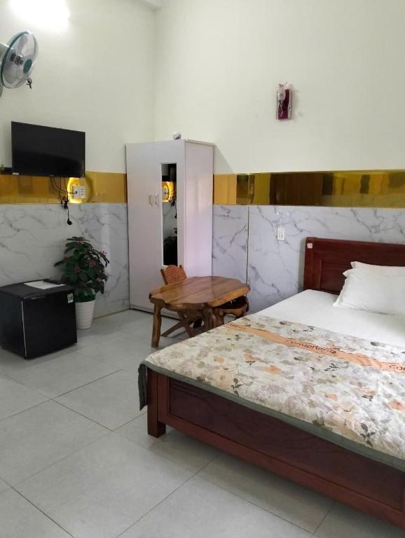Postel nebo postele na pokoji v ubytování Tam Ky XO Hotel
