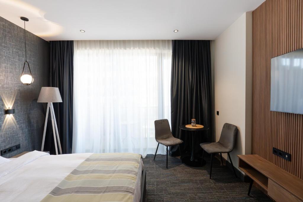 Postel nebo postele na pokoji v ubytování NOVA LUXE Hotel & Residences
