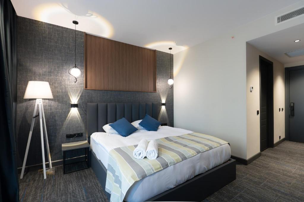 Postel nebo postele na pokoji v ubytování NOVA LUXE Hotel & Residences