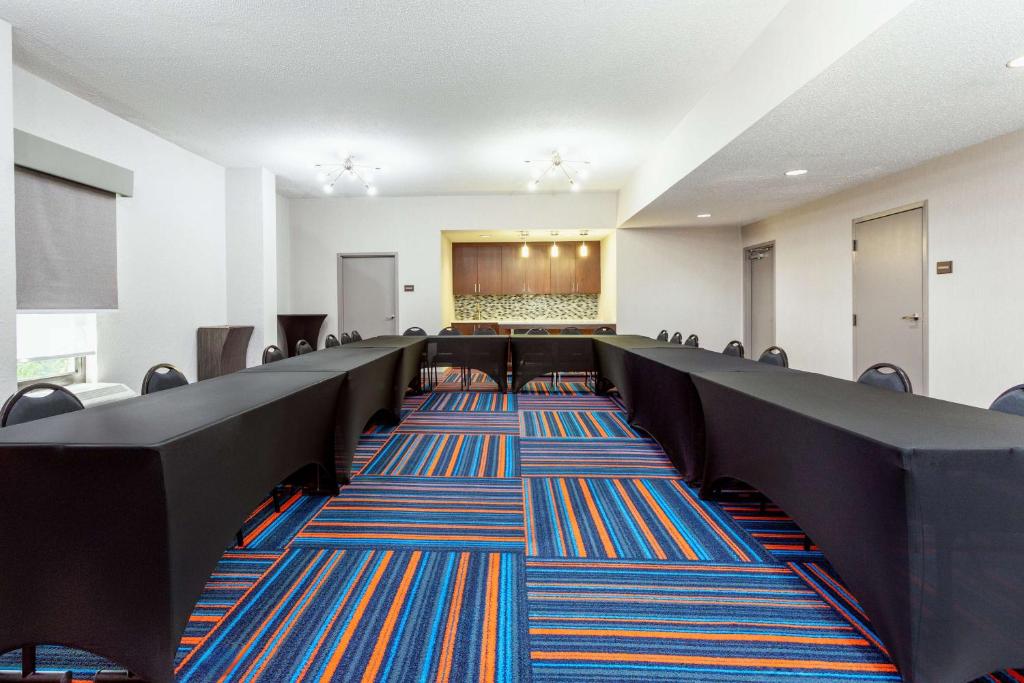 a conference room with chairs and a stage in the background at Hampton Inn Orlando-International Airport in Orlando