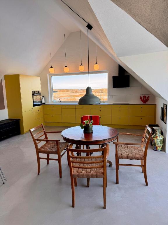 a kitchen with a table and chairs in a room at Panoramic Holiday Apartment - Dagmar in Ebeltoft