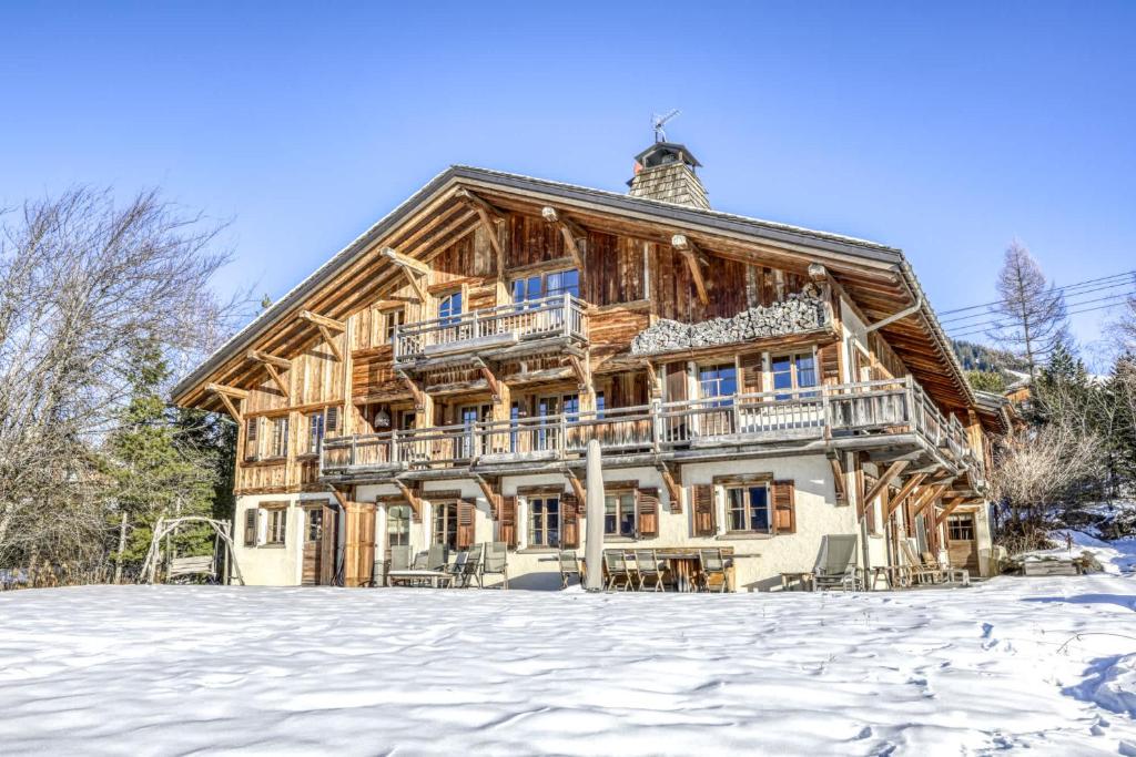 a large wooden house in the snow at Chalet Sapin in Megève