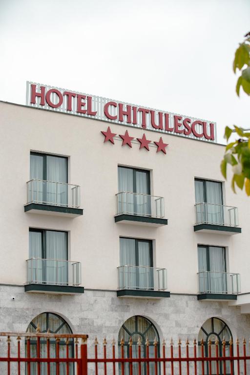a hotel building with red stars on it at CHITULESCU Hotel in Târgovişte