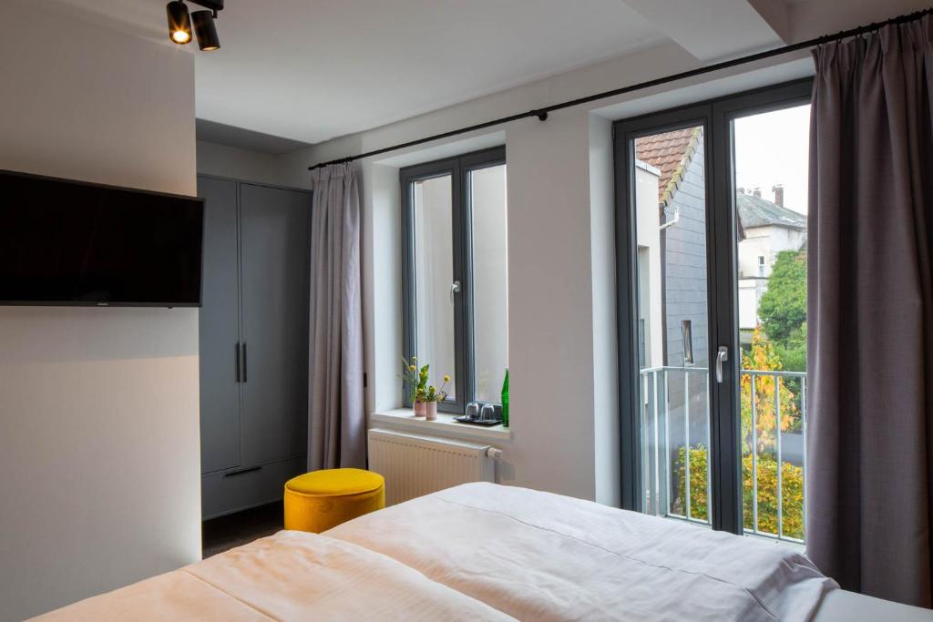 Postel nebo postele na pokoji v ubytování Wertschätzer Hotel - Krumme Str