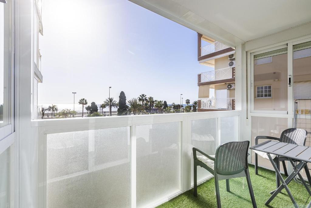 a balcony with chairs and a table with a view at A&N San Gerardo 123 in Torre del Mar