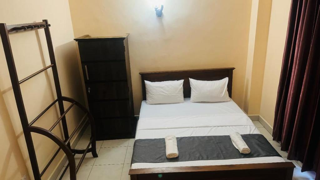 Postel nebo postele na pokoji v ubytování TASHINI Hotel