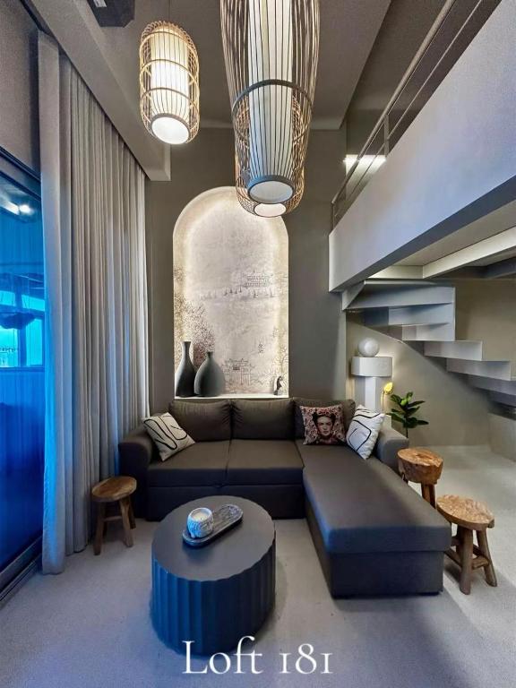 a living room with a couch and a table at Loft 181 by Oikies Rentals in Neoi Epivates