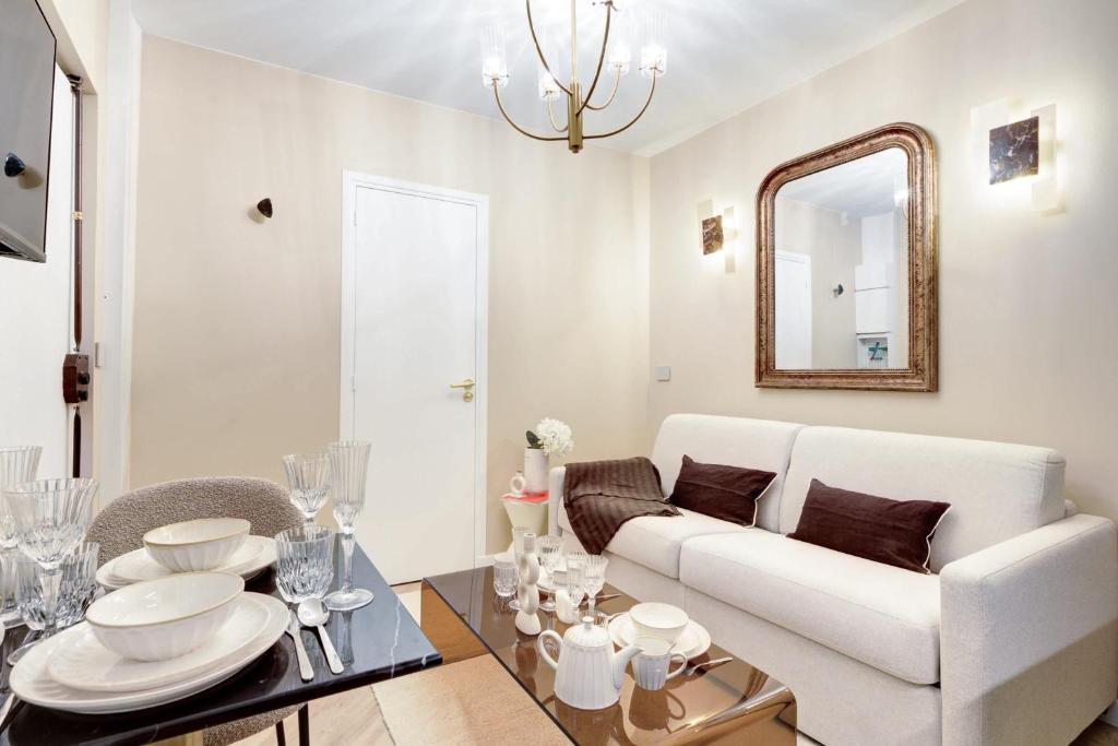 - un salon avec un canapé blanc et un miroir dans l'établissement Charming apartment with AC a proximite de Republique, à Paris