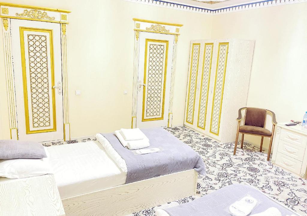 FAXRIDDIN OLD TOWN Hotel tesisinde bir odada yatak veya yataklar