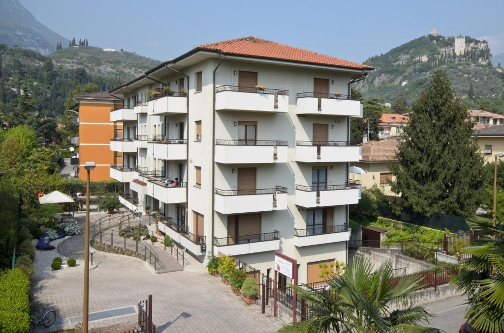 an apartment building with balconies on a mountain at Residence La Porta Del Cuore in Arco